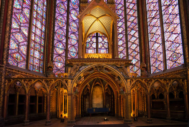 Stained glass windows of Saint Chapelle with rose window, medieval church of 13c., Paris France