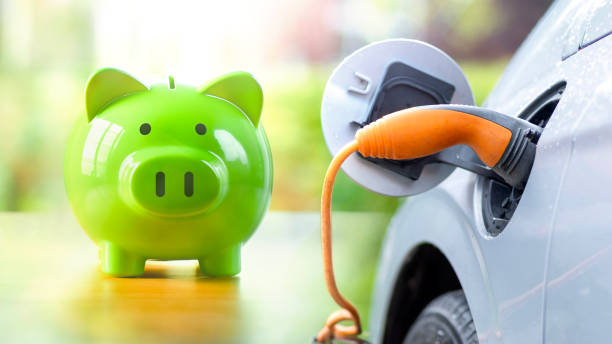 Green piggy bank while charging electric vehicle